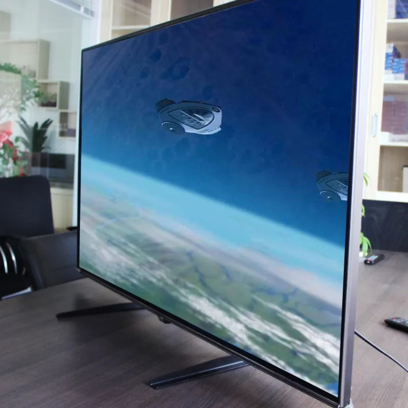 Socle de table portant un grand écran sur un meuble de bureau